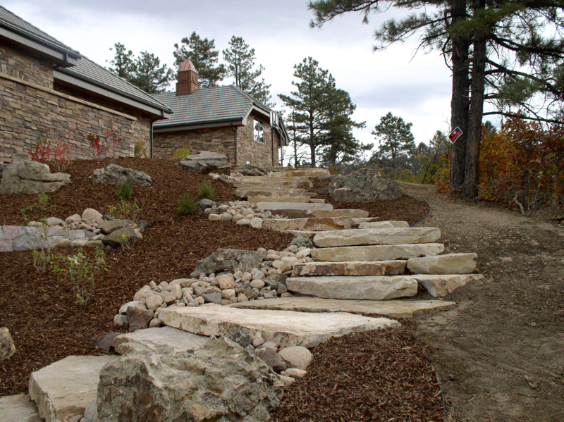 Hardscape installation with boulders and flagstone